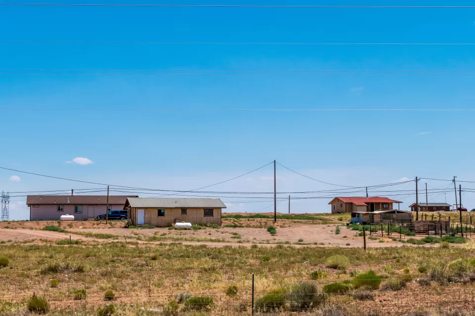 View of three manufactured homes on a hill somewhere in Navajo Nation